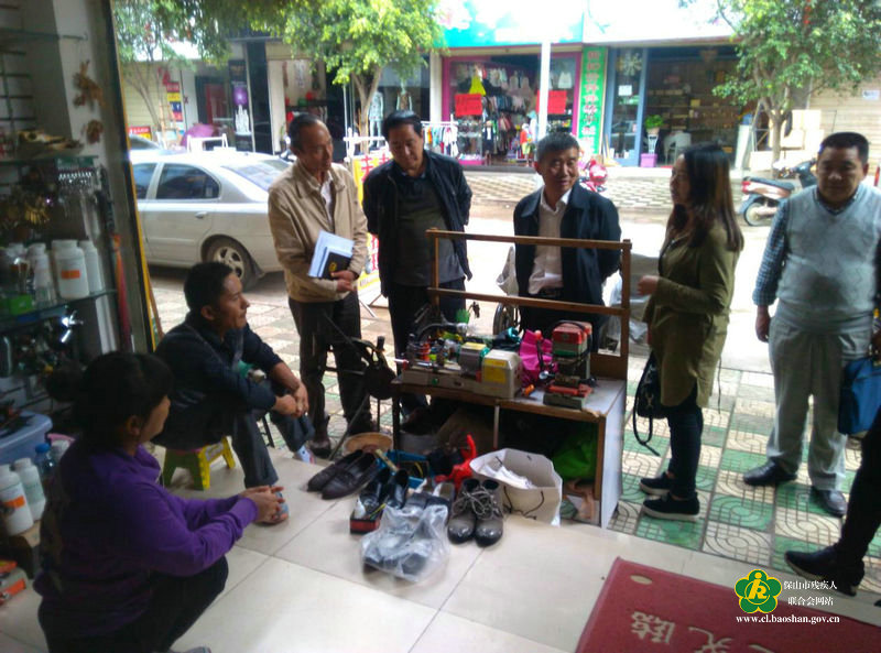 (市人大刘忆宾<右三>副主任到双下肢残疾人魏自英夫妇补鞋店了解经济收入和生活情况)